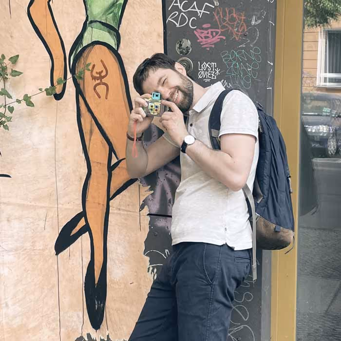 Artem Sapegin is making a photo with a toy camera