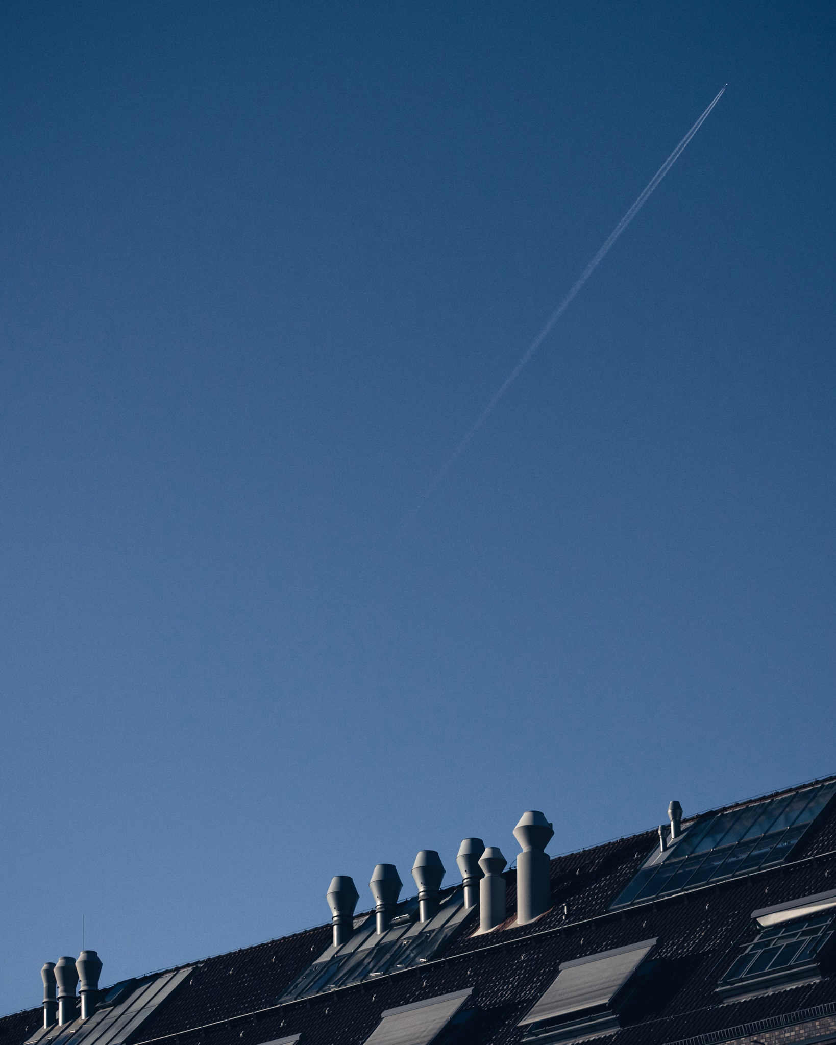 Airplane flying over a roof (Berlin, Germany)