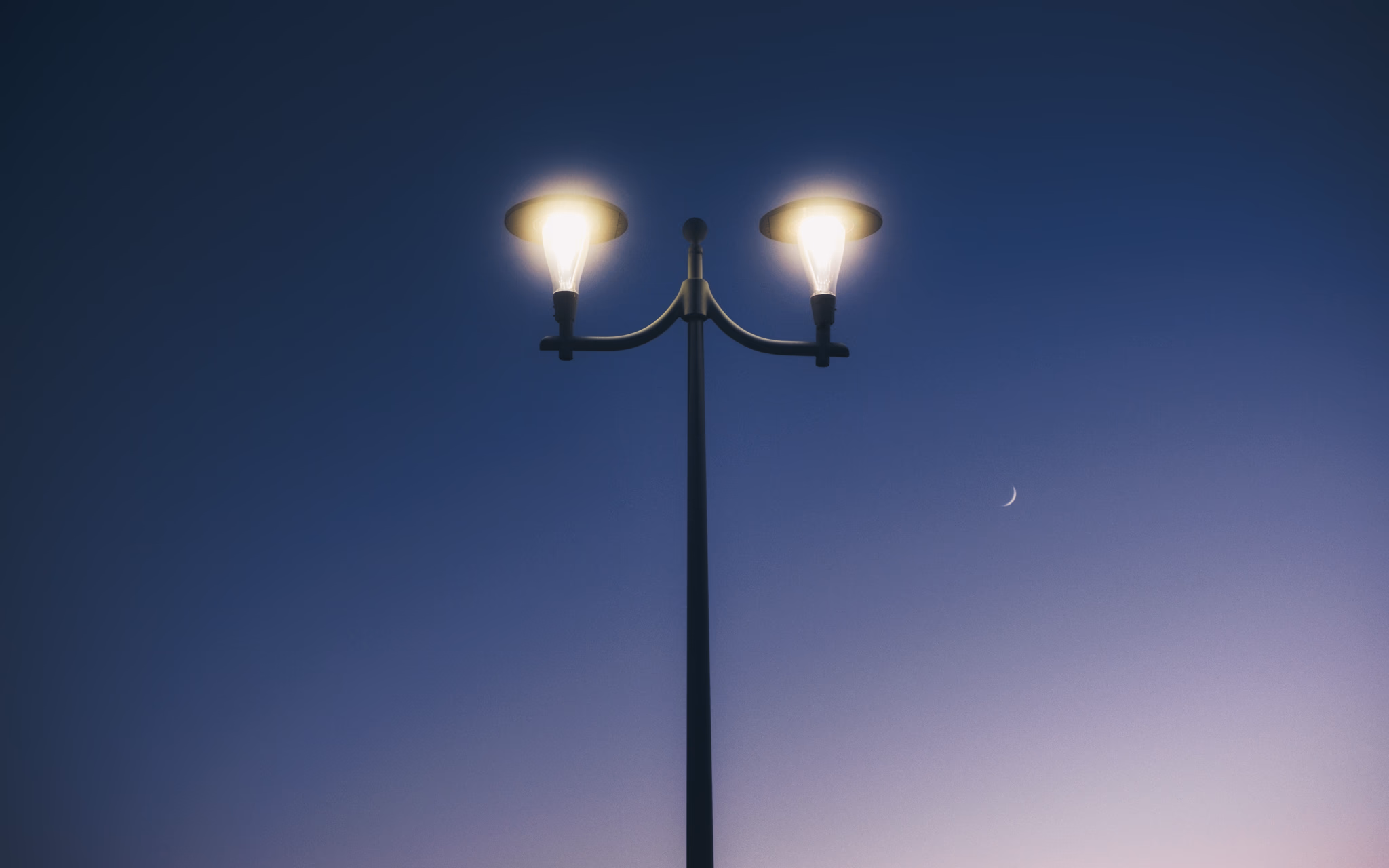 New moon behind street light (La Pobla de Farnals, Spain)